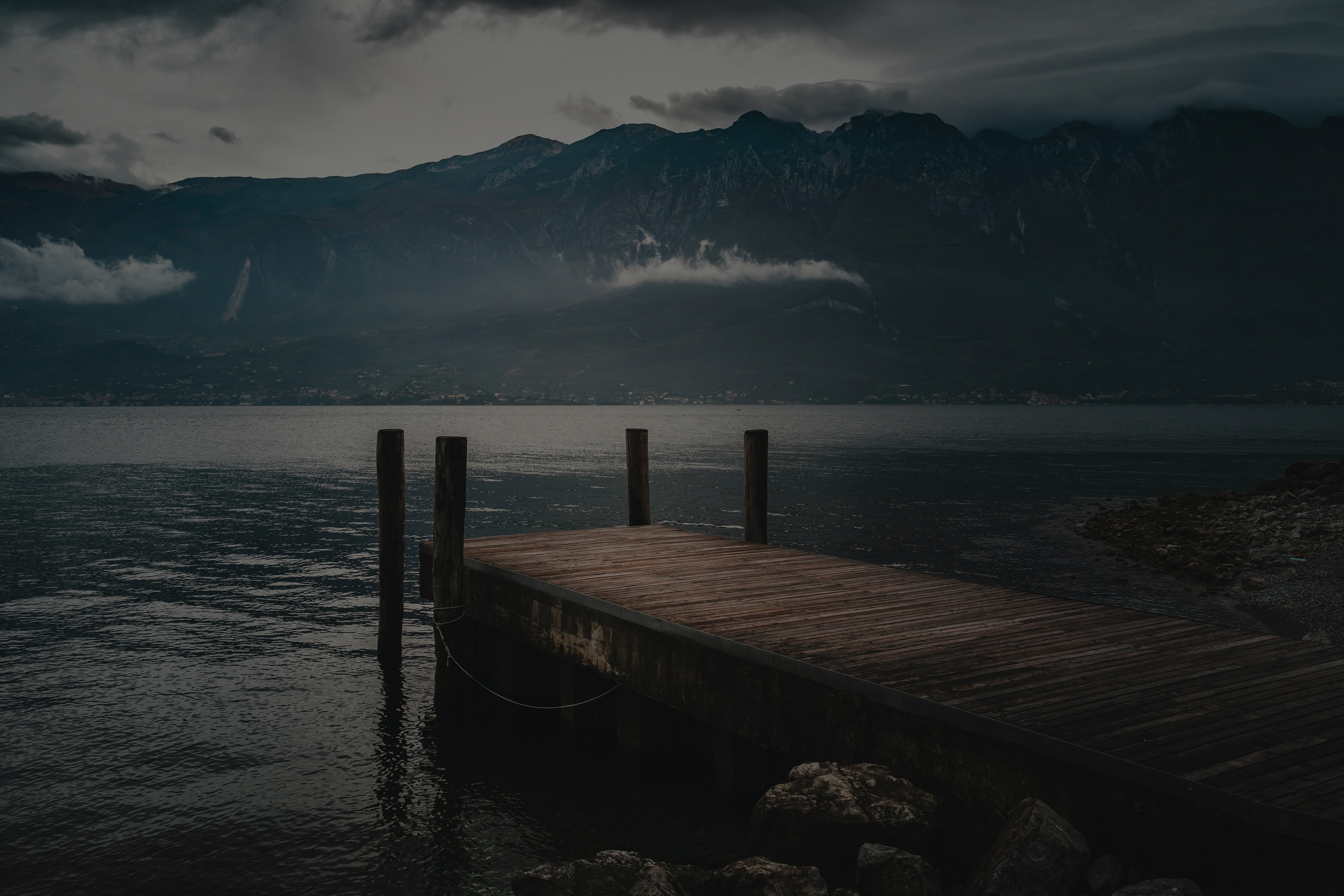Dock on the lake with mountains in background